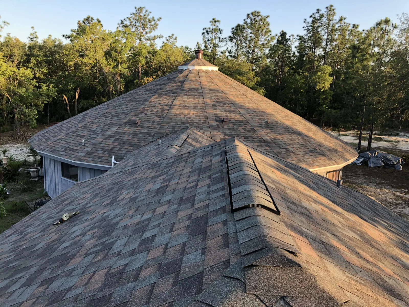 Finished architectural shingle roof at sunset by Guardian Roofing Systems