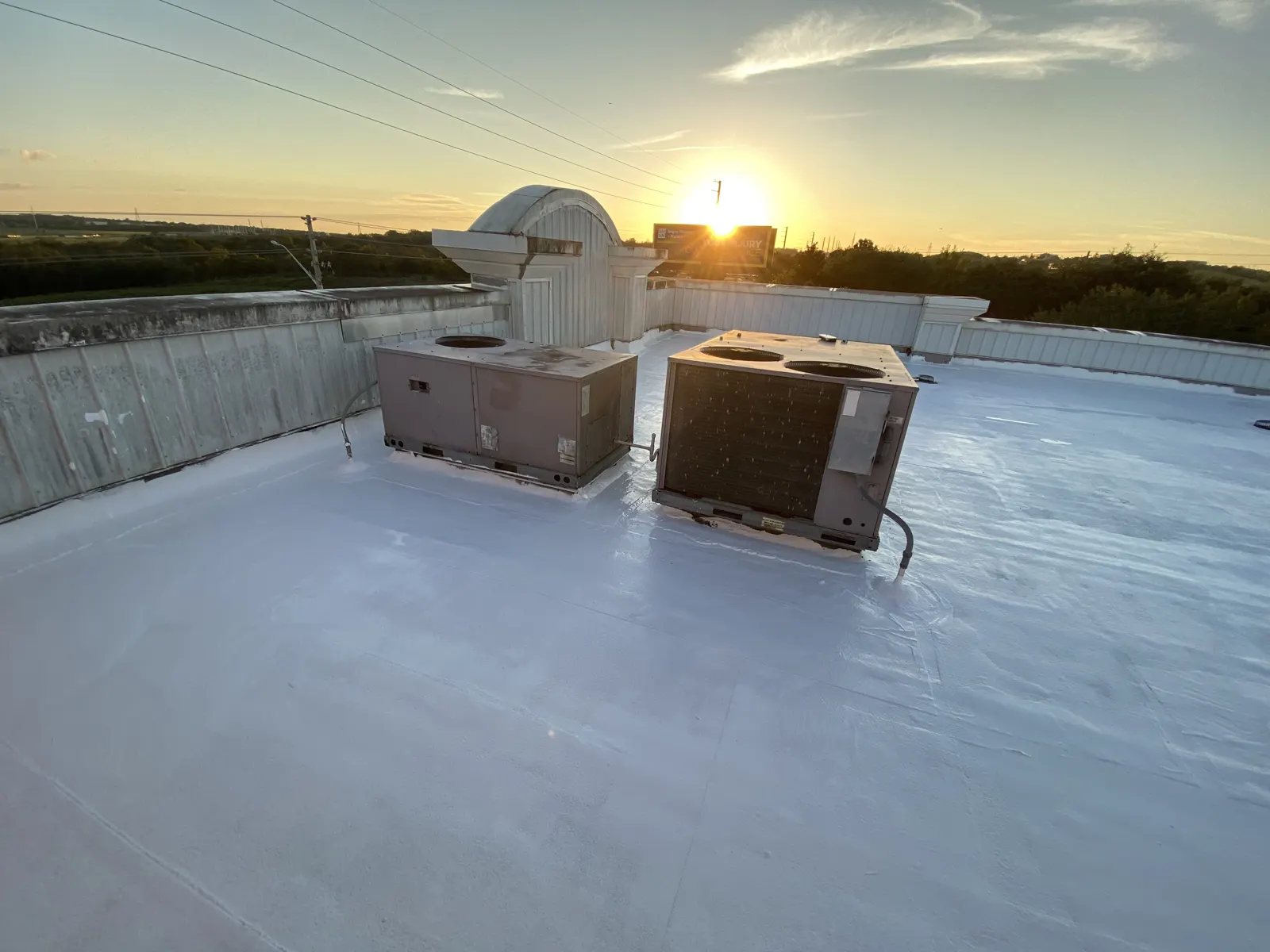 Silicone coated commercial flat roof with rooftop units