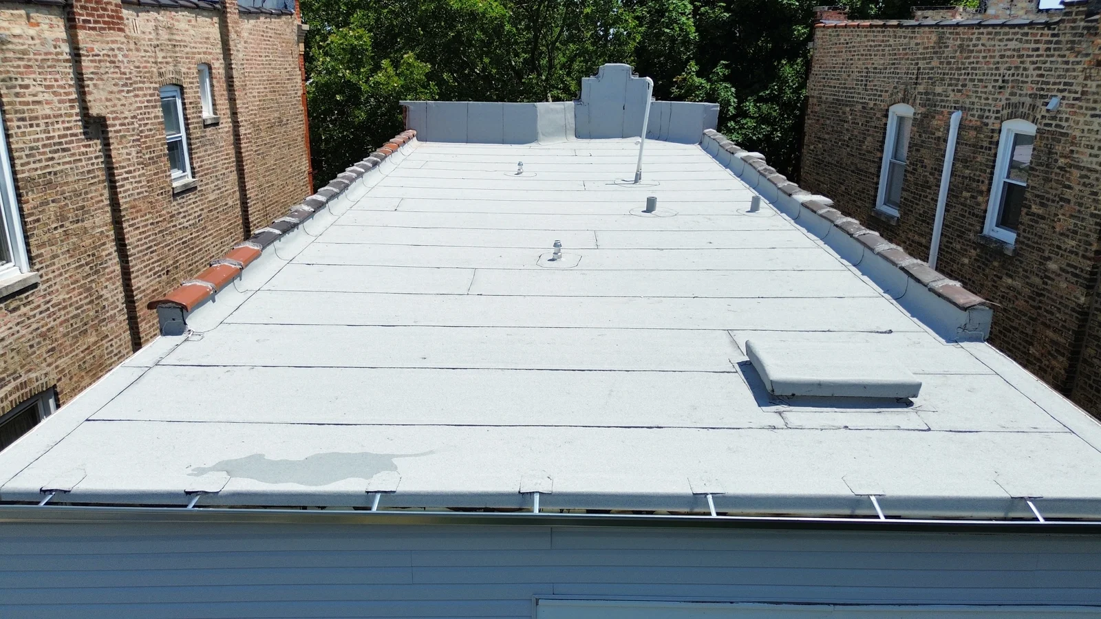 Finished silver roof coating with access hatch in Chicago