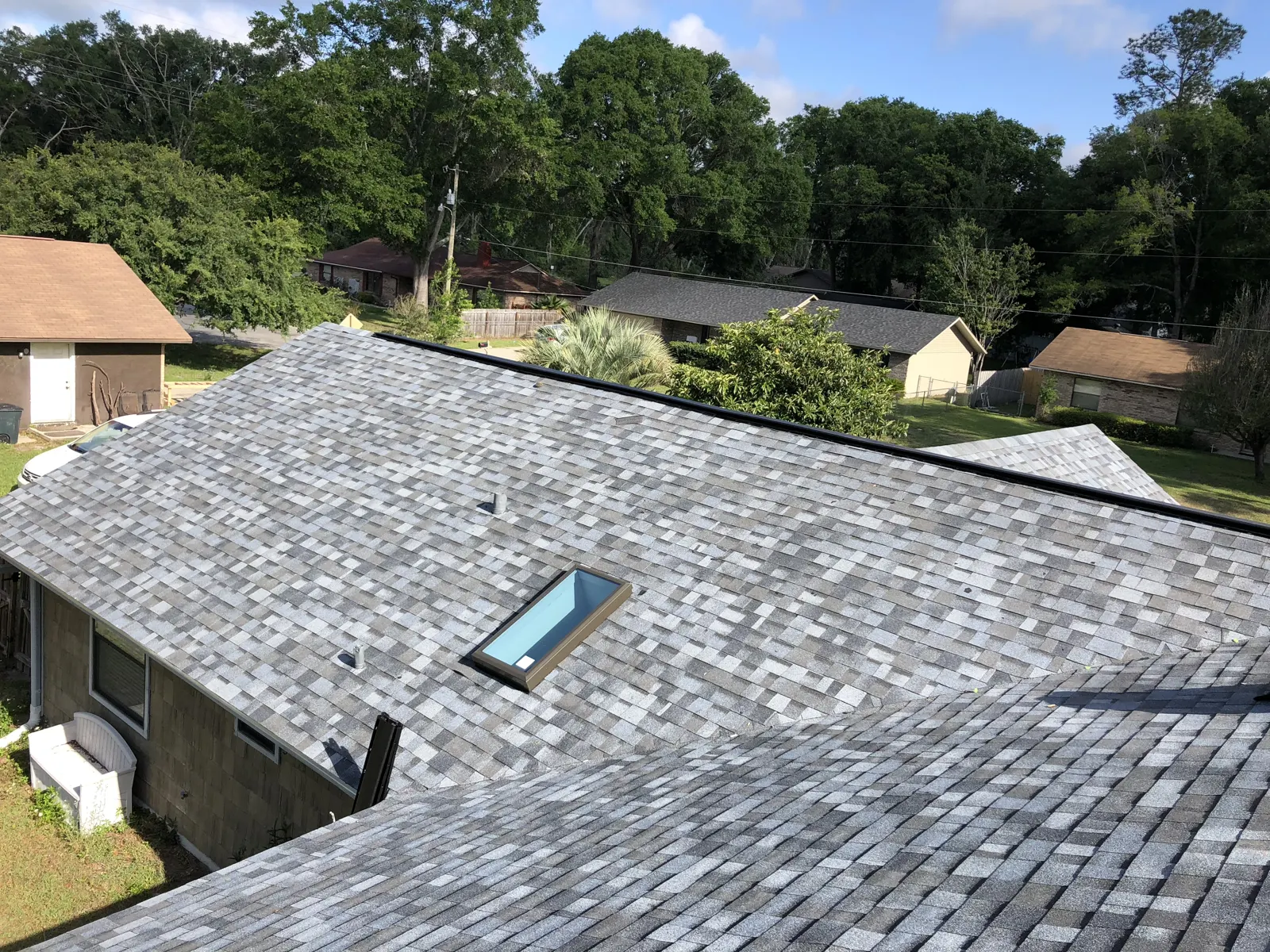 Gray shingle roof with a reflashed skylight on a Hoffman Estates, IL home