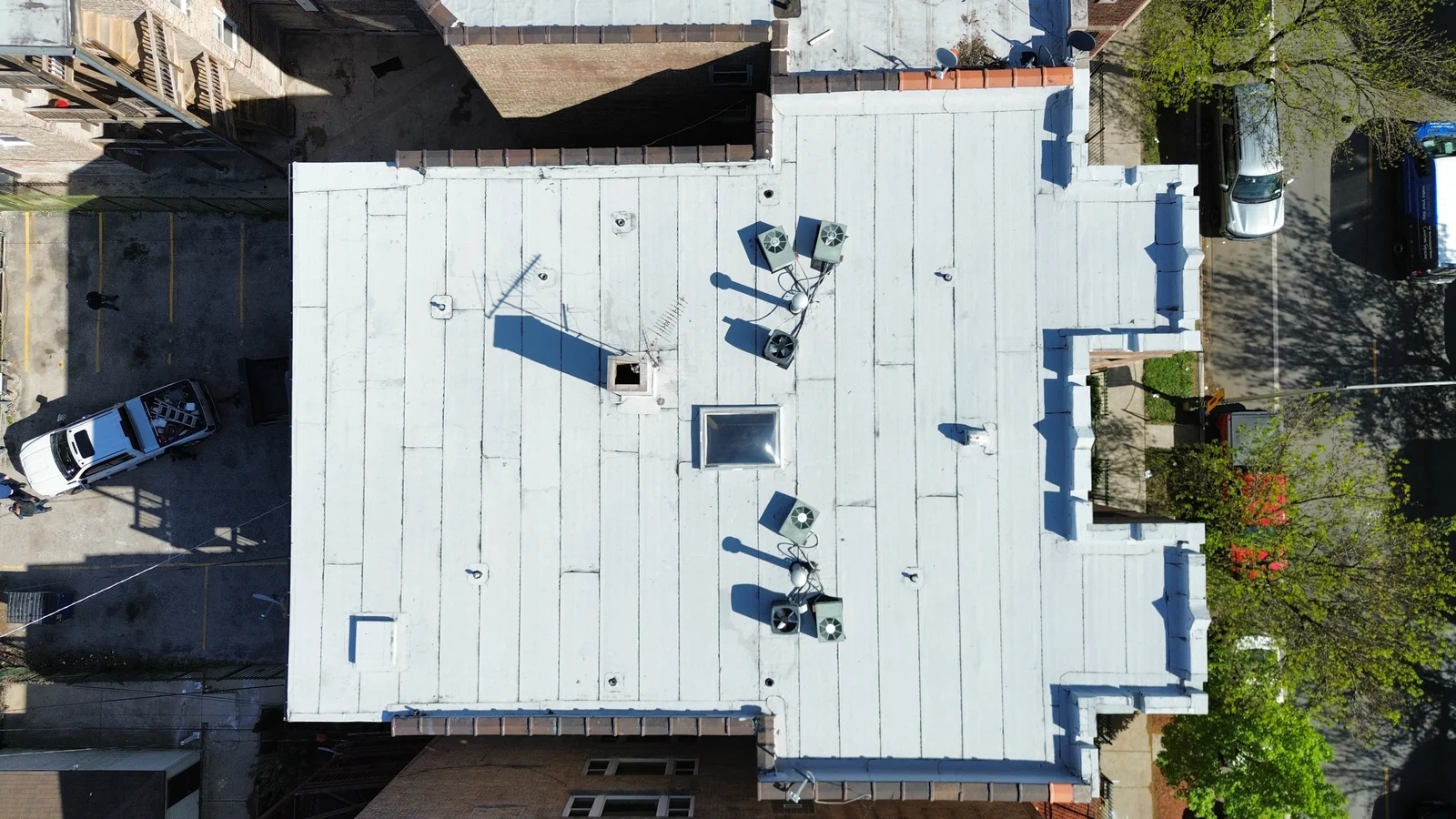 L-shaped white flat roof after installation seen from above in Chicago