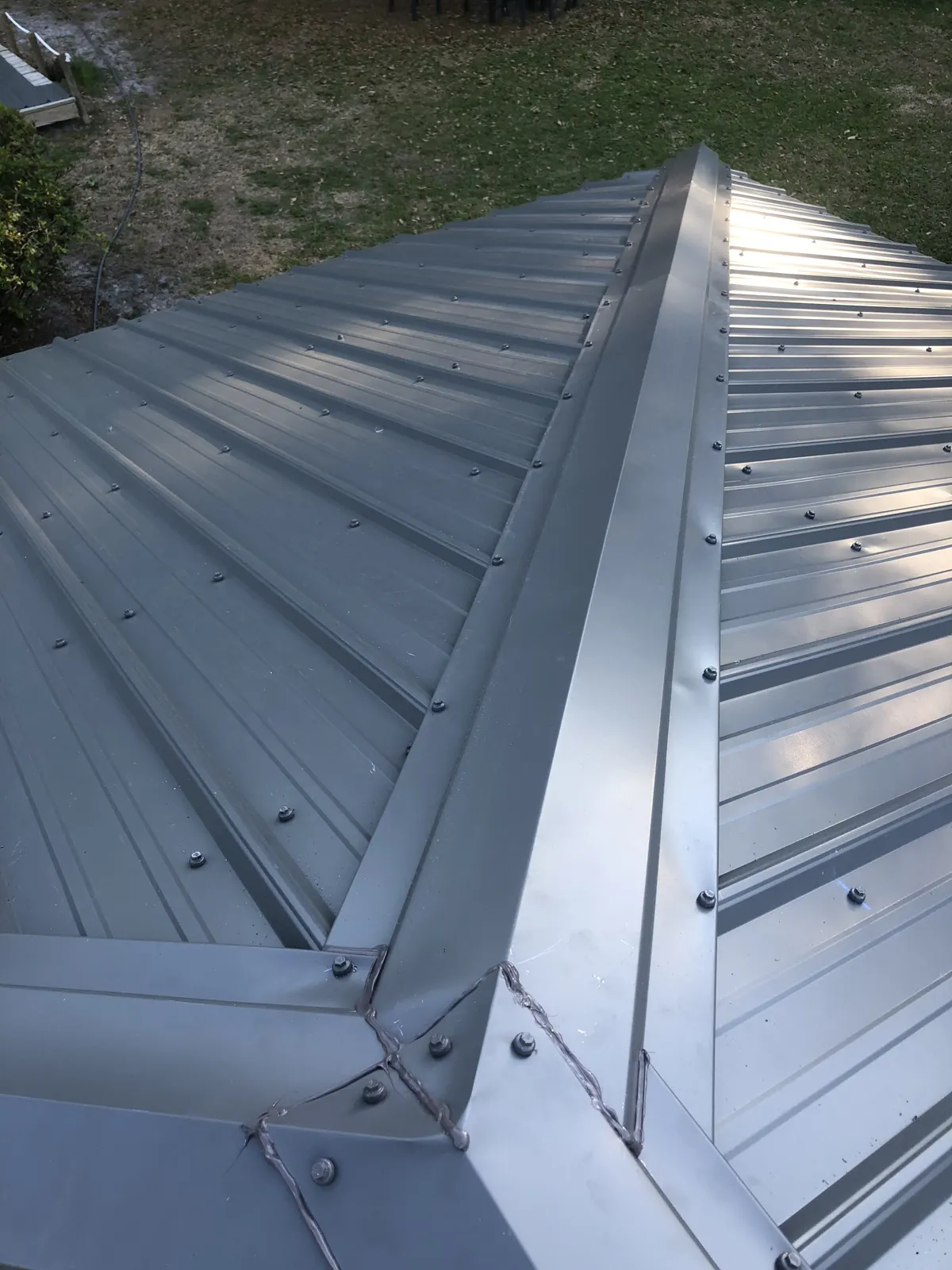Silver metal hip roof section on an older Riverside, IL home