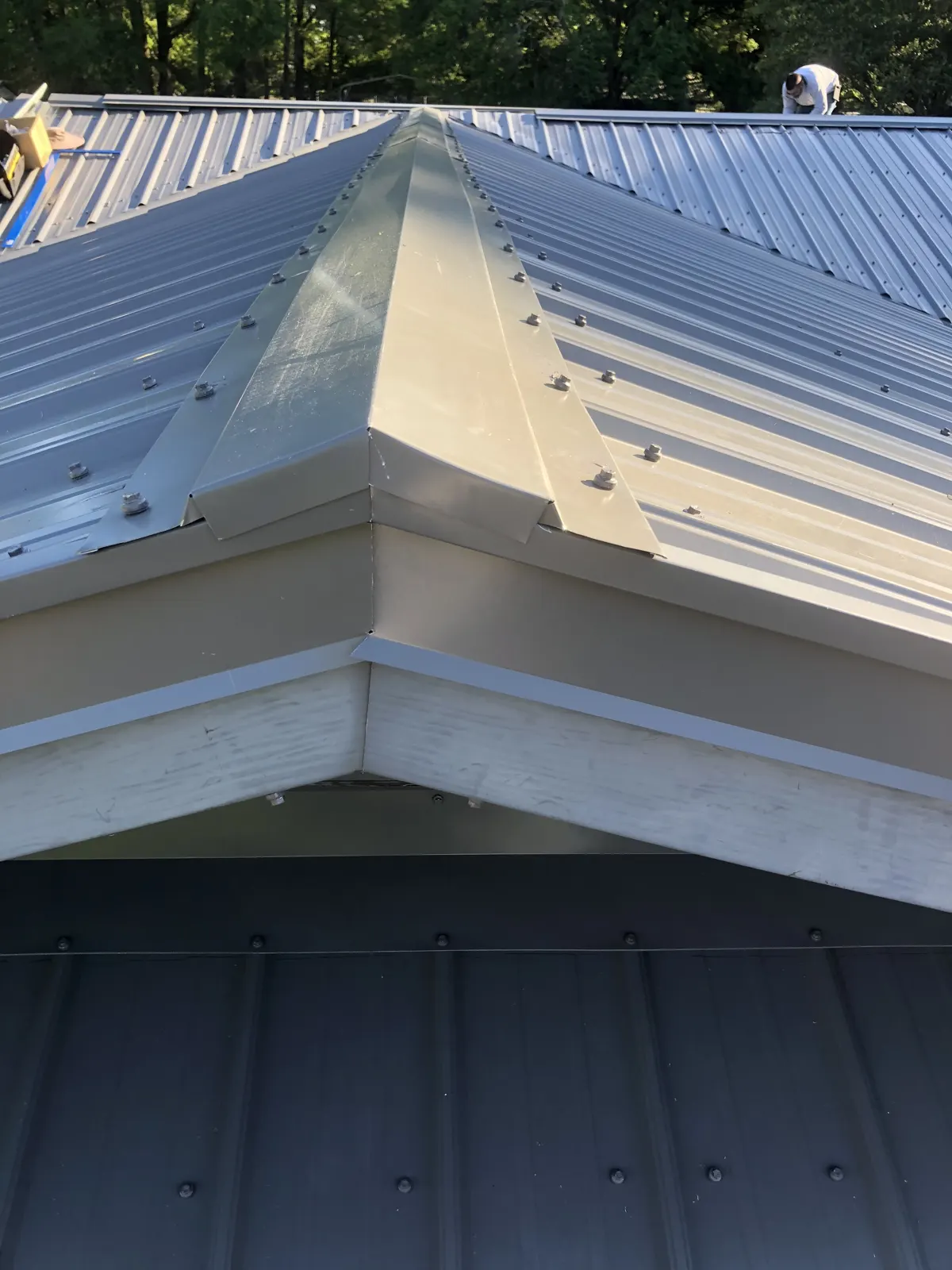 Standing seam metal roof hip detail installed by Guardian Roofing Systems