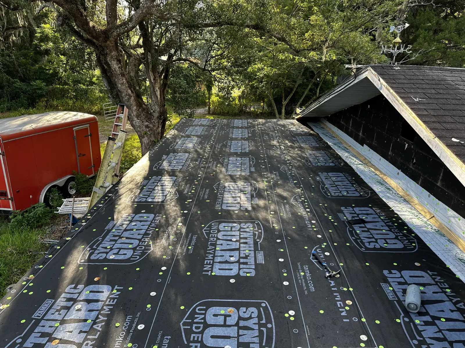 Synthetic underlayment rolled across a stripped deck on a Hoffman Estates, IL roof