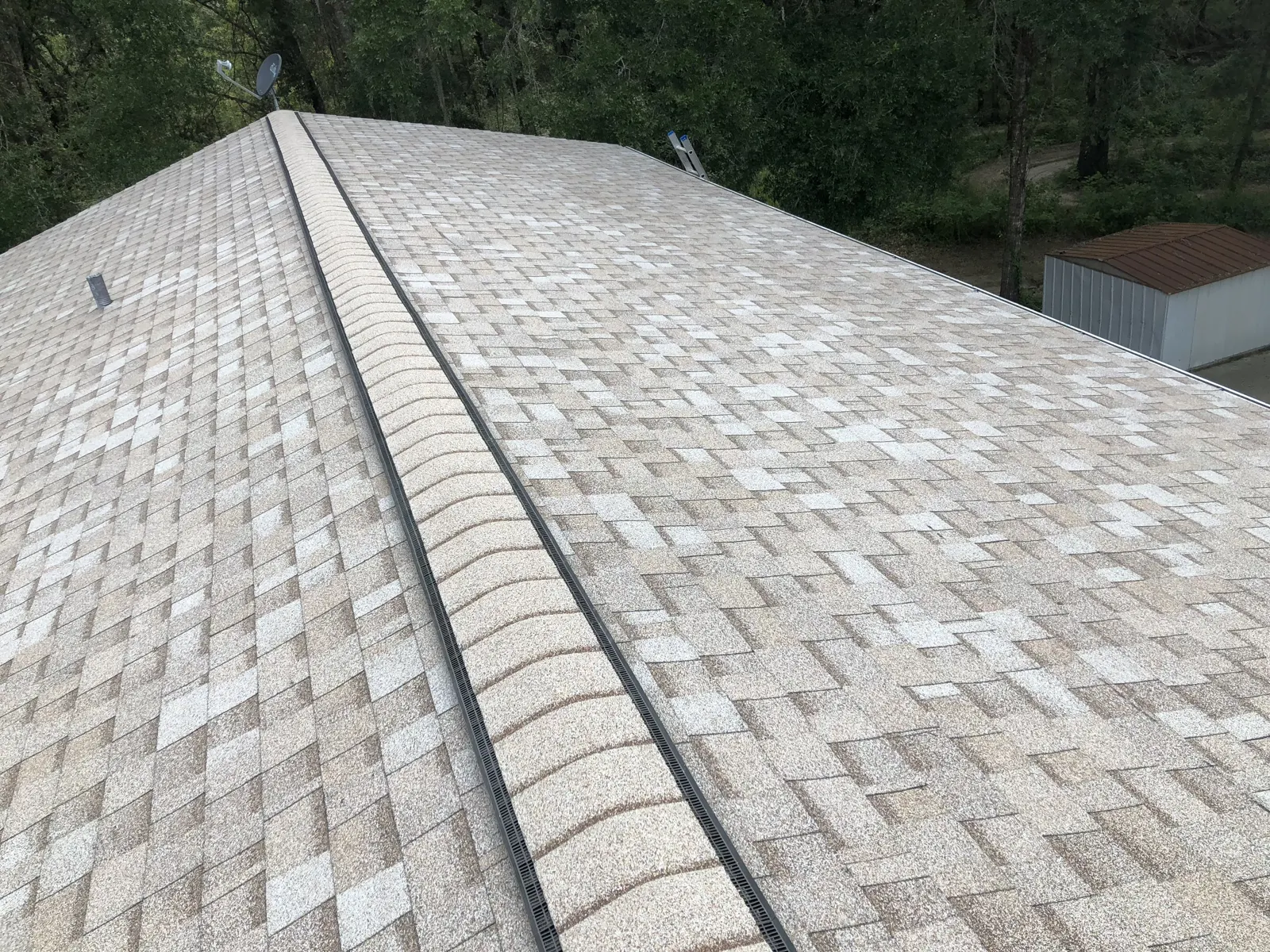 Tan shingle roof with continuous ridge vent and a clean eave edge on a home near Alsip, IL